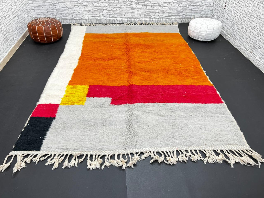 Orange Moroccan wool rug with modern color block design in red, beige, yellow, and black, handmade by Berber artisans
