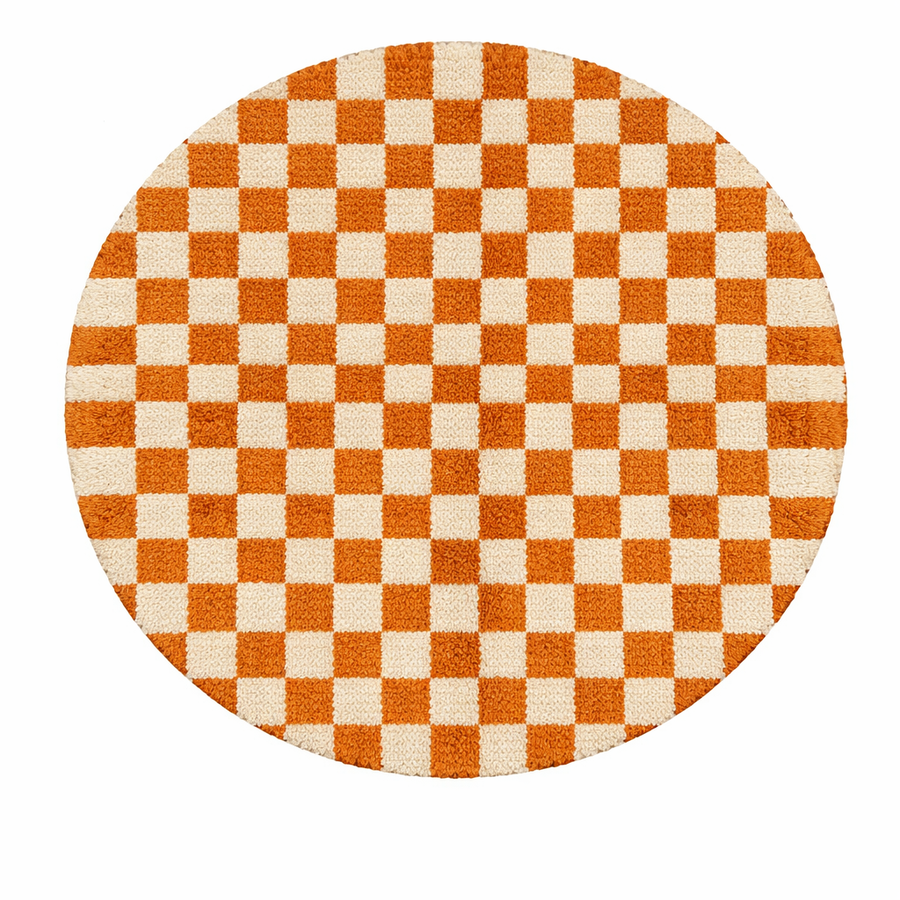 Handmade round Moroccan wool rug with orange and white checkerboard pattern on white background