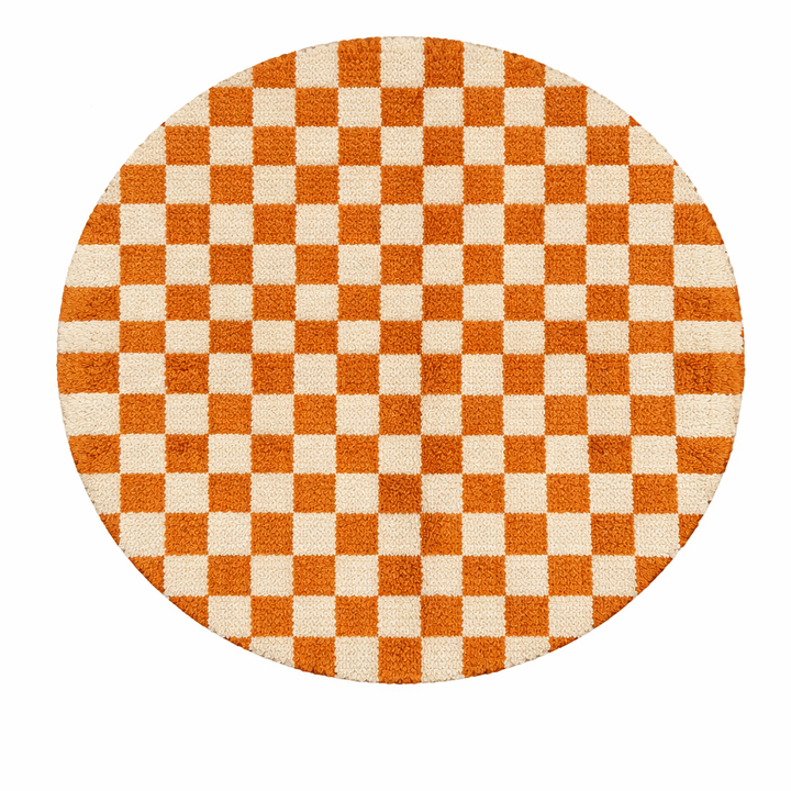 Handmade round Moroccan wool rug with orange and white checkerboard pattern on white background