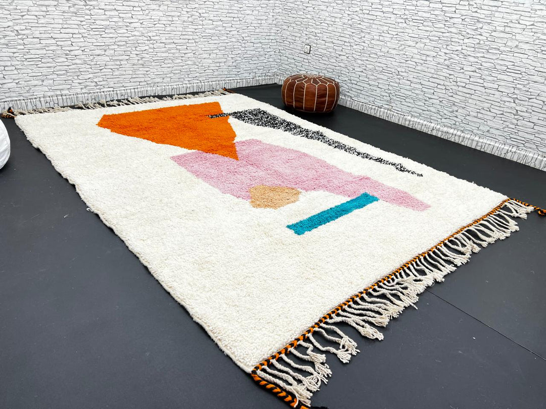 Handwoven Moroccan wool rug in orange, pink, black, and ivory – abstract geometric Berber carpet handmade in Morocco