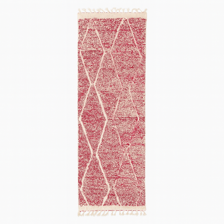 Handwoven pink Moroccan wool runner rug with white diamond lattice pattern.