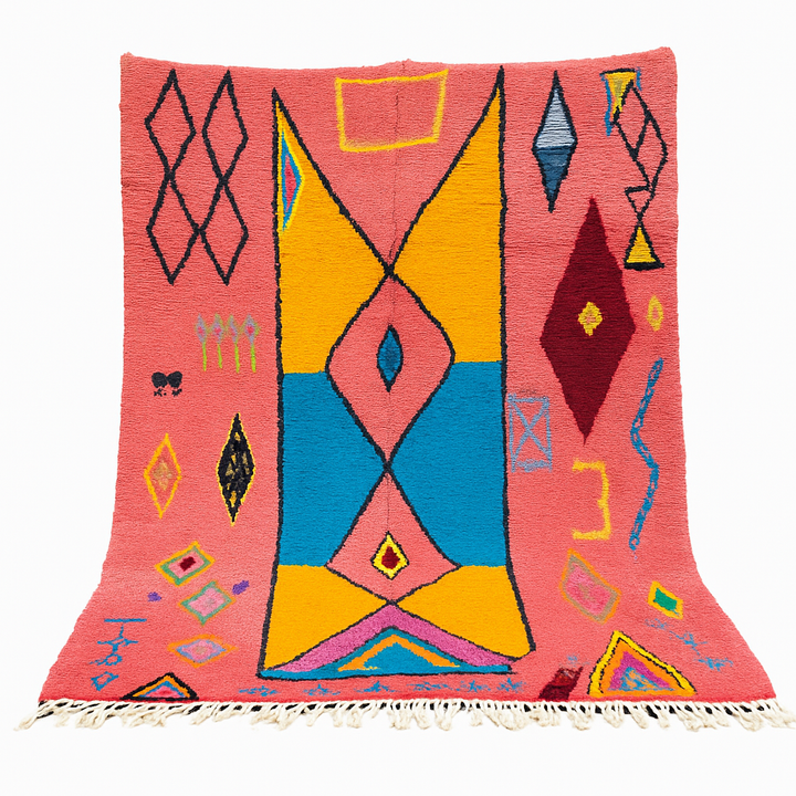 Handwoven pink Moroccan wool rug with colorful abstract geometric Berber design