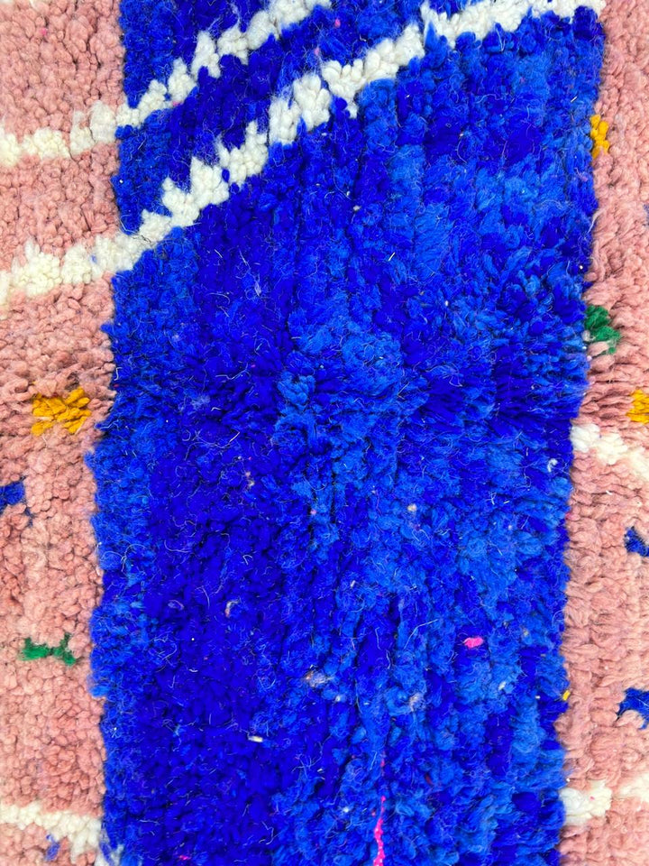 Handmade Moroccan wool rug in bright pink with colorful dotted patterns and white abstract Berber lines