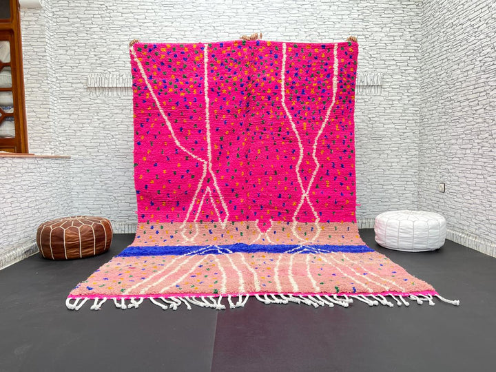 Handmade Moroccan wool rug in bright pink with colorful dotted patterns and white abstract Berber lines