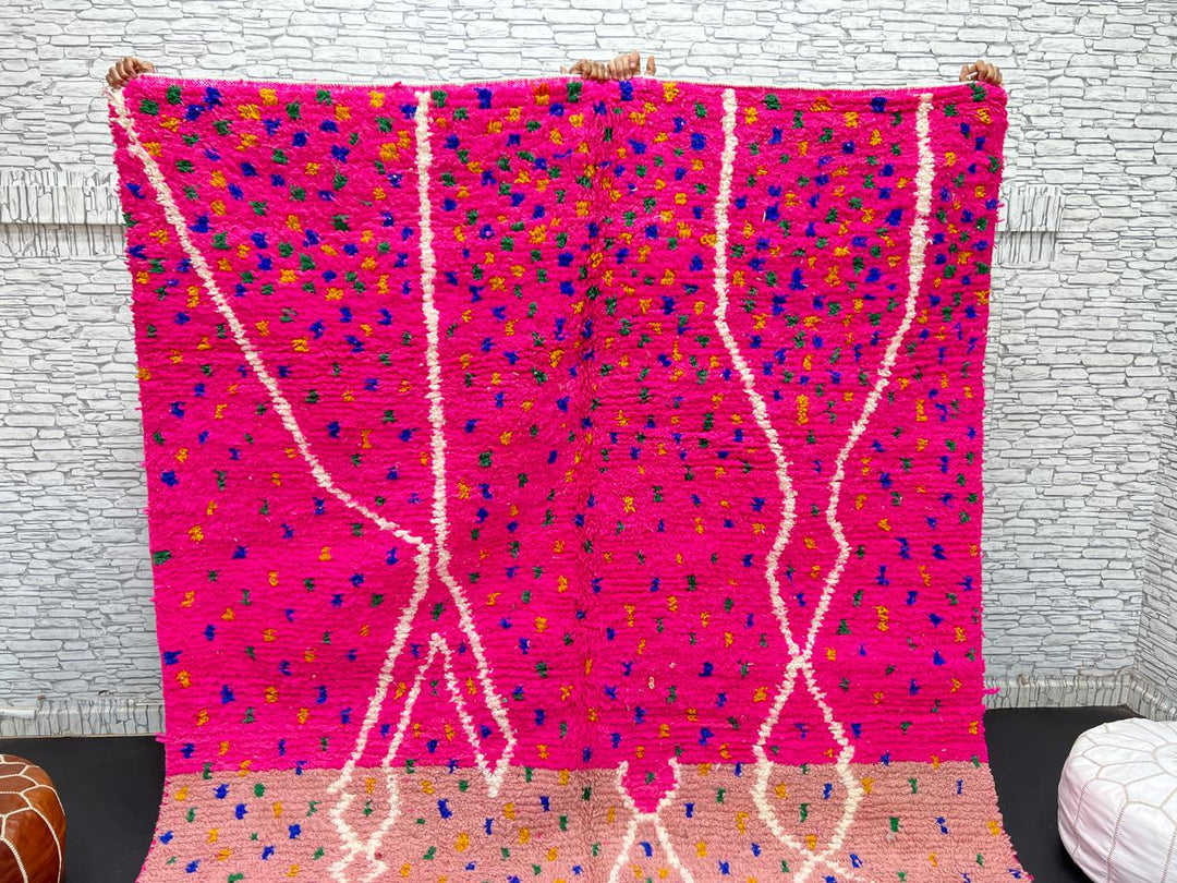 Handmade Moroccan wool rug in bright pink with colorful dotted patterns and white abstract Berber lines