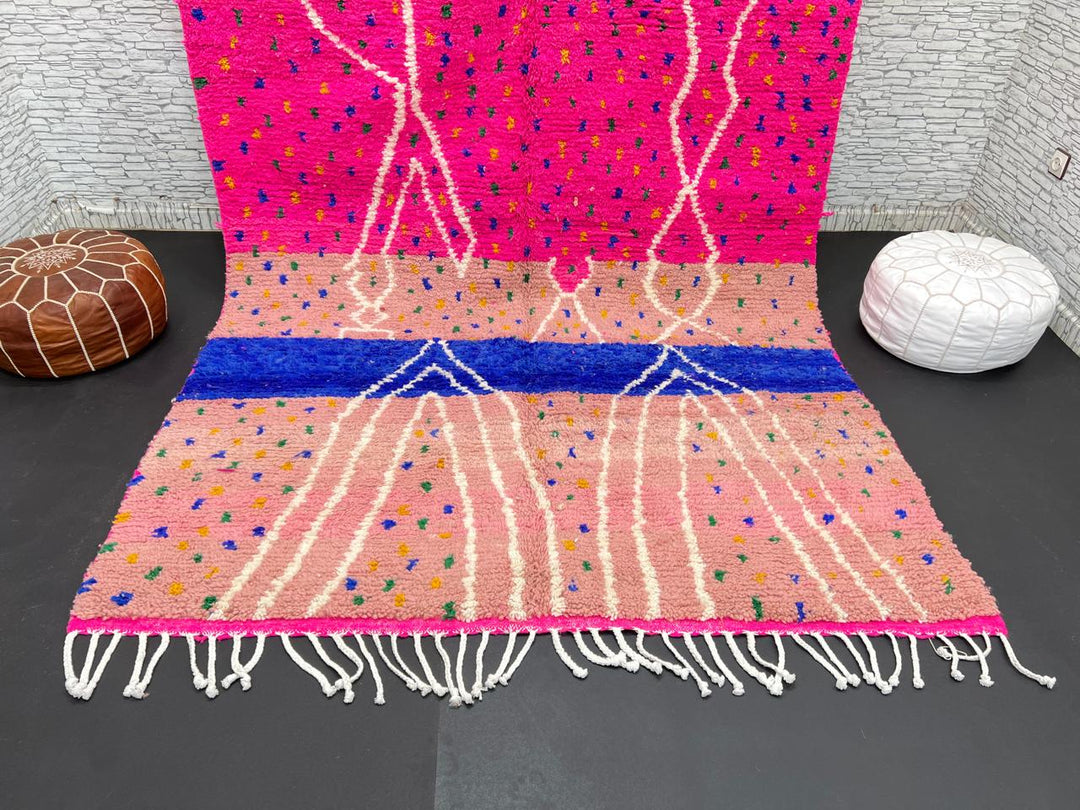 Handmade Moroccan wool rug in bright pink with colorful dotted patterns and white abstract Berber lines