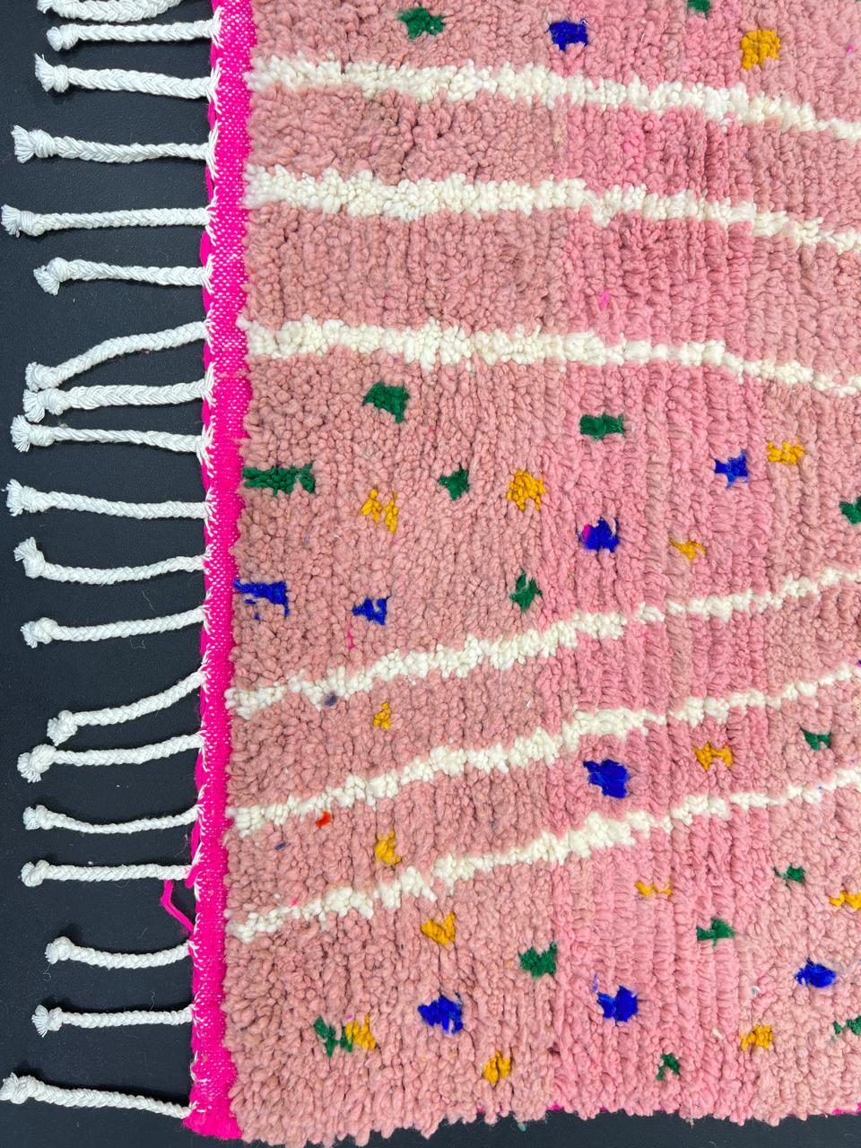 Handmade Moroccan wool rug in bright pink with colorful dotted patterns and white abstract Berber lines