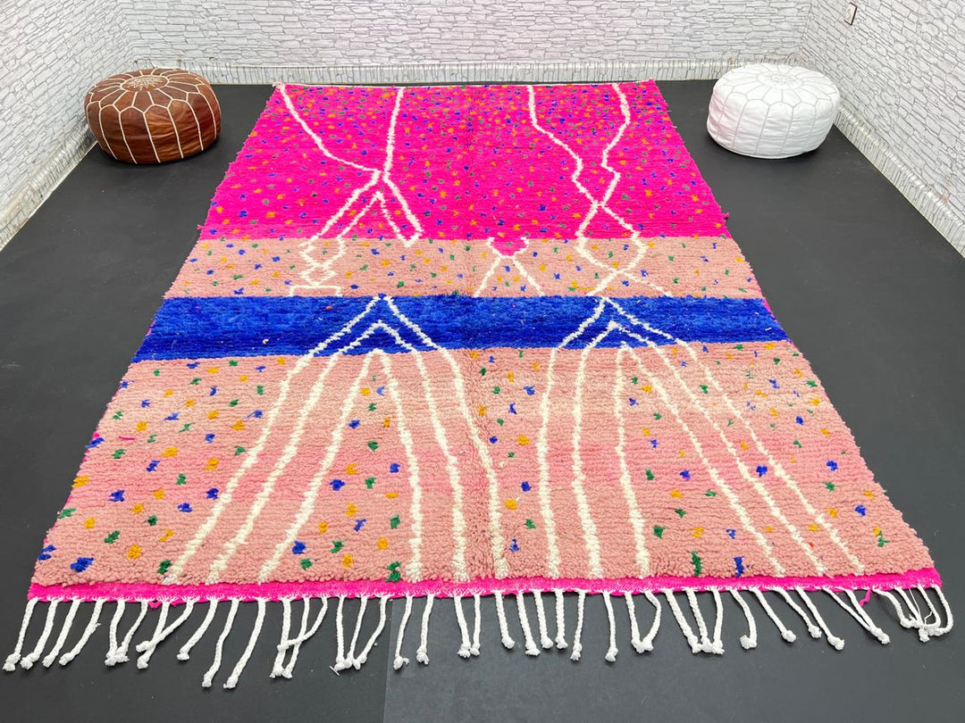 Handmade Moroccan wool rug in bright pink with colorful dotted patterns and white abstract Berber lines