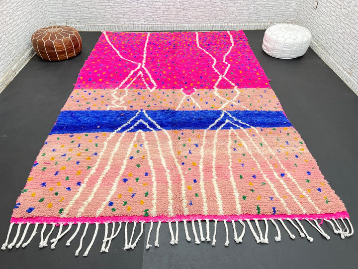 Handmade Moroccan wool rug in bright pink with colorful dotted patterns and white abstract Berber lines