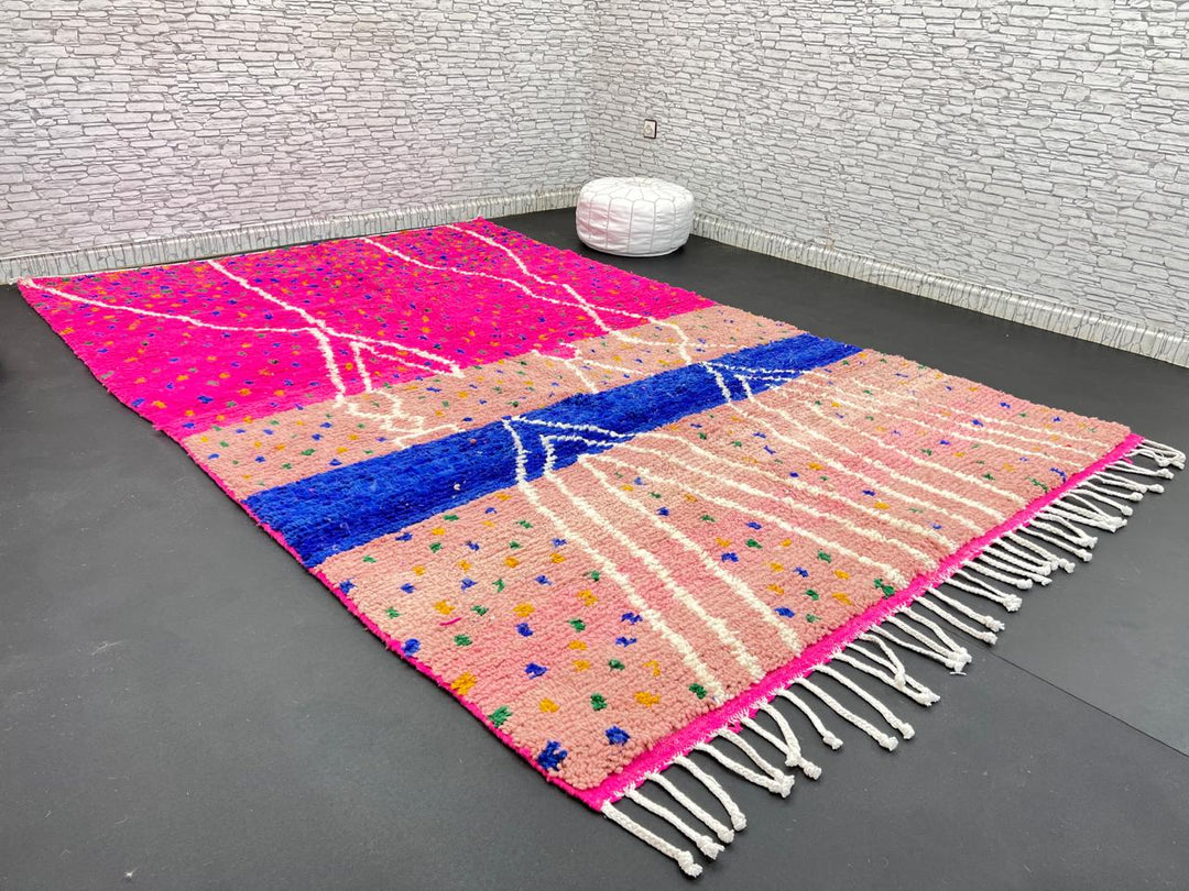 Handmade Moroccan wool rug in bright pink with colorful dotted patterns and white abstract Berber lines