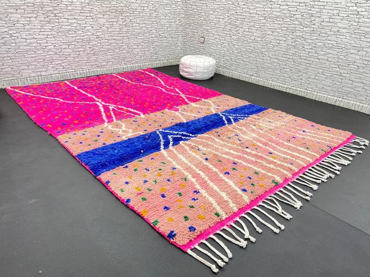 Handmade Moroccan wool rug in bright pink with colorful dotted patterns and white abstract Berber lines