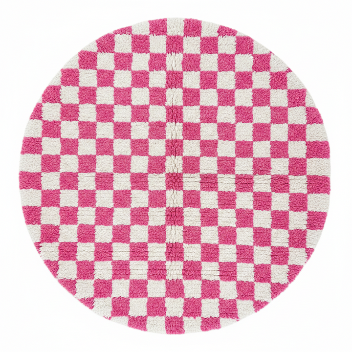 Handmade round Moroccan wool rug with pink and white checkerboard pattern and plush shag texture