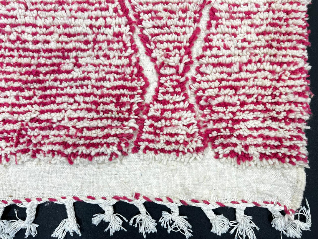 Handwoven pink Moroccan wool runner rug with white diamond lattice pattern.