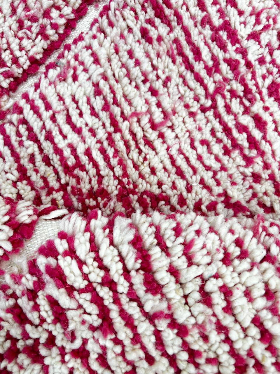 Handwoven pink Moroccan wool runner rug with white diamond lattice pattern.