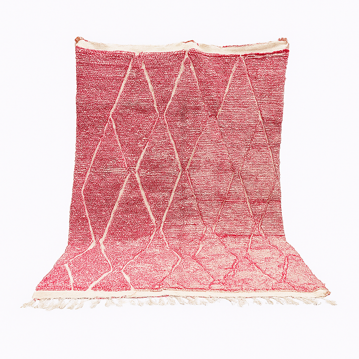 Pink Moroccan wool rug with cream diamond pattern, handmade by Berber artisans in the Atlas Mountains