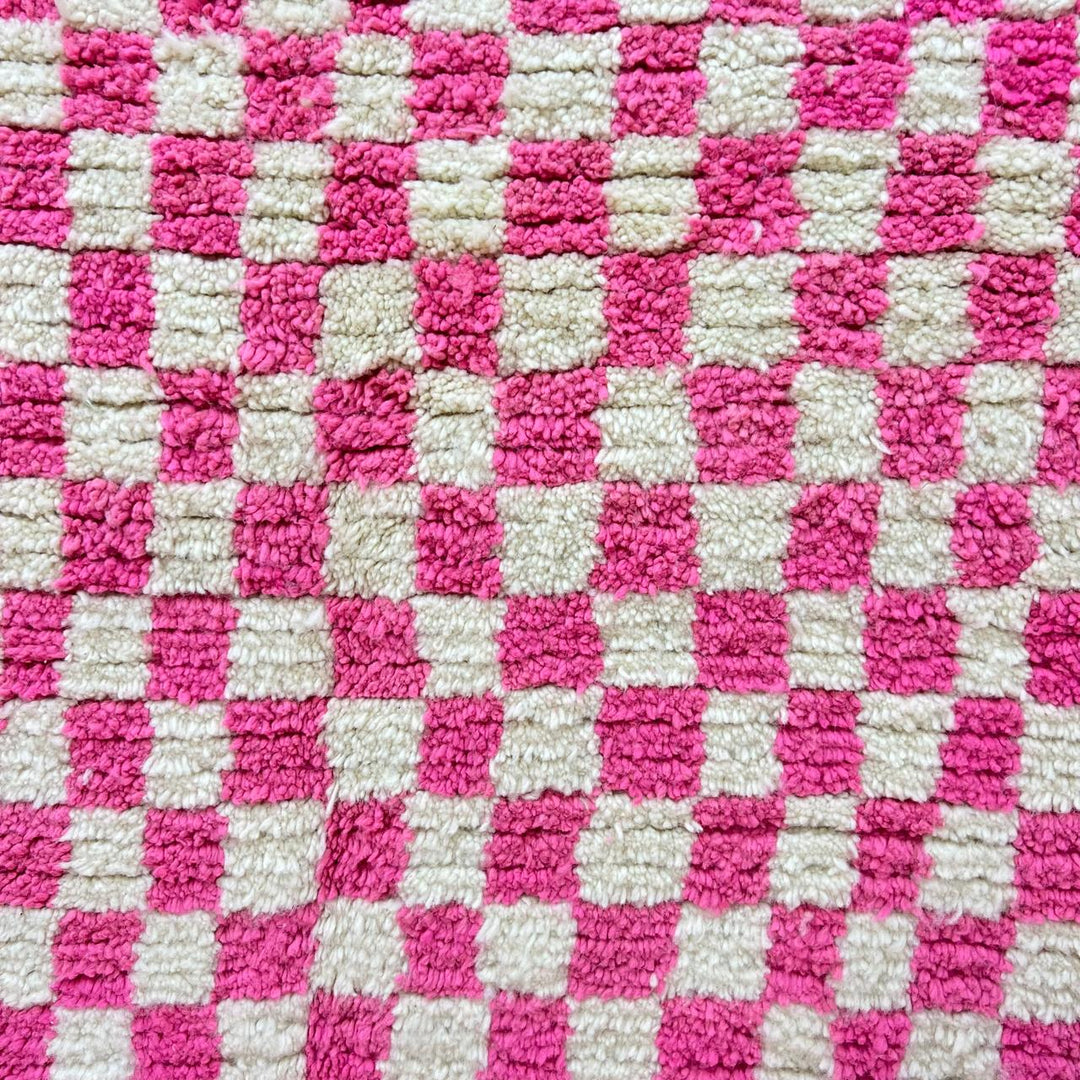 Pink and white checkered Moroccan wool runner rug with handmade Berber texture
