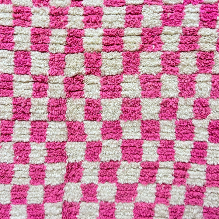 Pink and white checkered Moroccan wool runner rug with handmade Berber texture