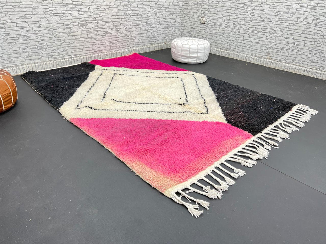 Handmade Moroccan wool rug in pink, black, and ivory with bold diamond geometric design