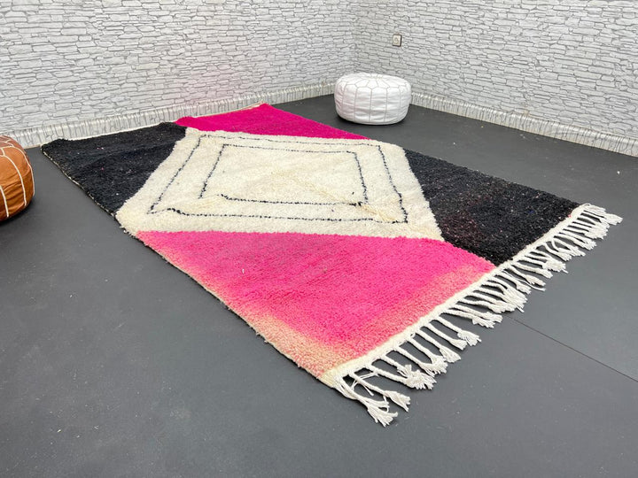 Handmade Moroccan wool rug in pink, black, and ivory with bold diamond geometric design