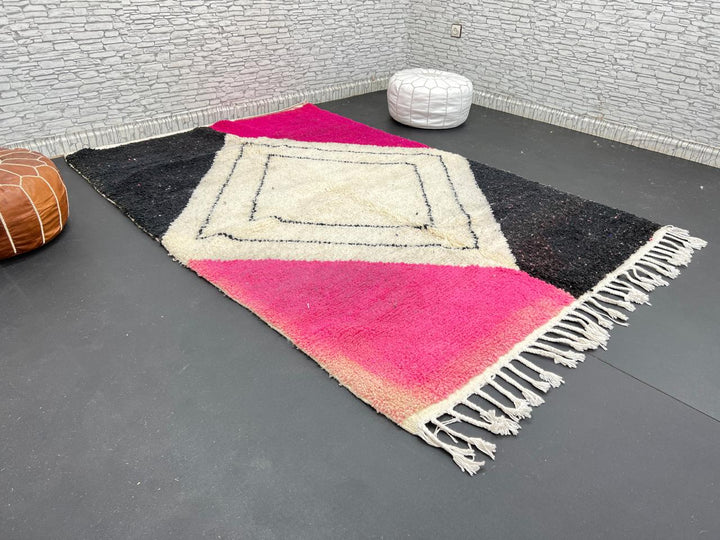 Handmade Moroccan wool rug in pink, black, and ivory with bold diamond geometric design