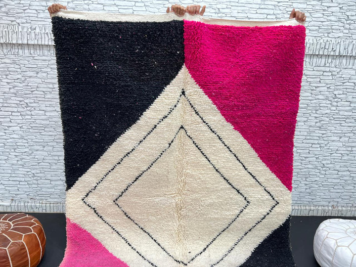 Handmade Moroccan wool rug in pink, black, and ivory with bold diamond geometric design
