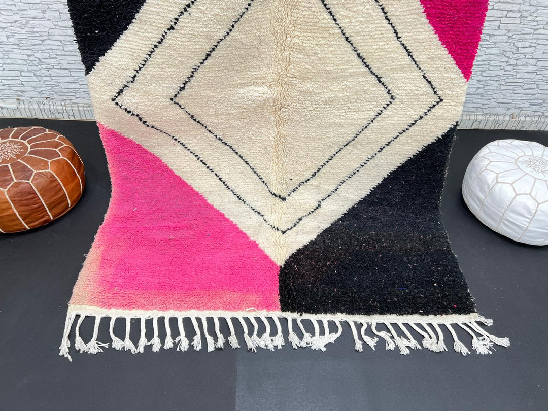 Handmade Moroccan wool rug in pink, black, and ivory with bold diamond geometric design