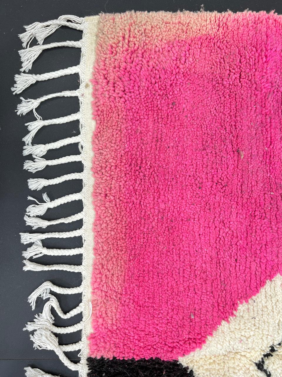 Handmade Moroccan wool rug in pink, black, and ivory with bold diamond geometric design