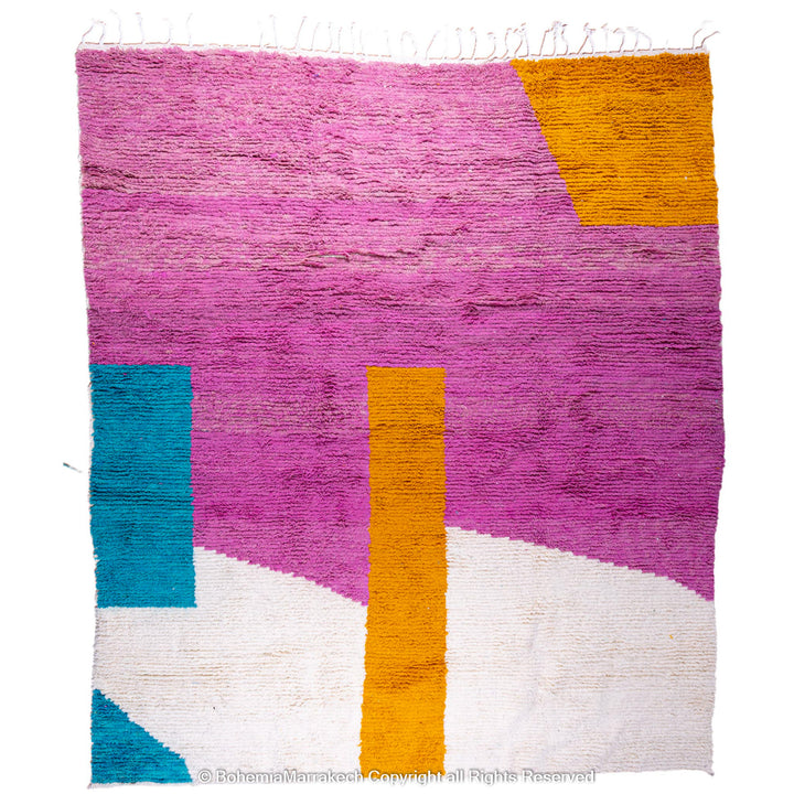 Handmade pink Moroccan wool rug with bold geometric color blocks, crafted by Berber artisans