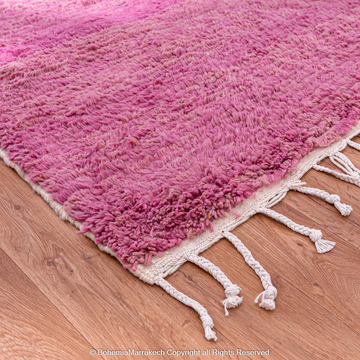 Handmade pink Moroccan wool rug with bold geometric color blocks, crafted by Berber artisans