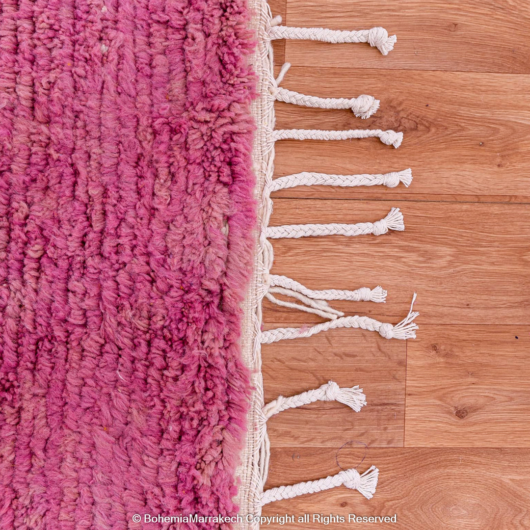Handmade pink Moroccan wool rug with bold geometric color blocks, crafted by Berber artisans