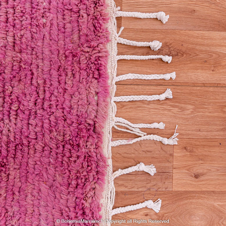 Handmade pink Moroccan wool rug with bold geometric color blocks, crafted by Berber artisans