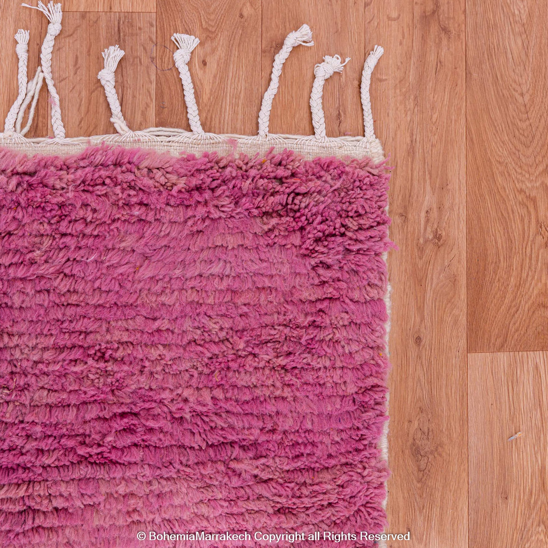 Handmade pink Moroccan wool rug with bold geometric color blocks, crafted by Berber artisans