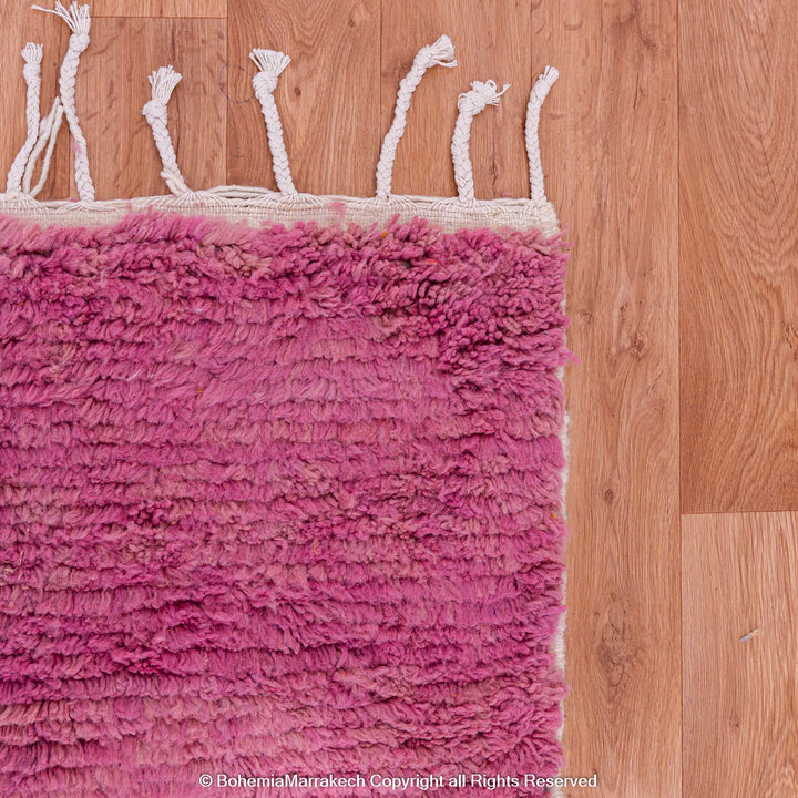 Handmade pink Moroccan wool rug with bold geometric color blocks, crafted by Berber artisans