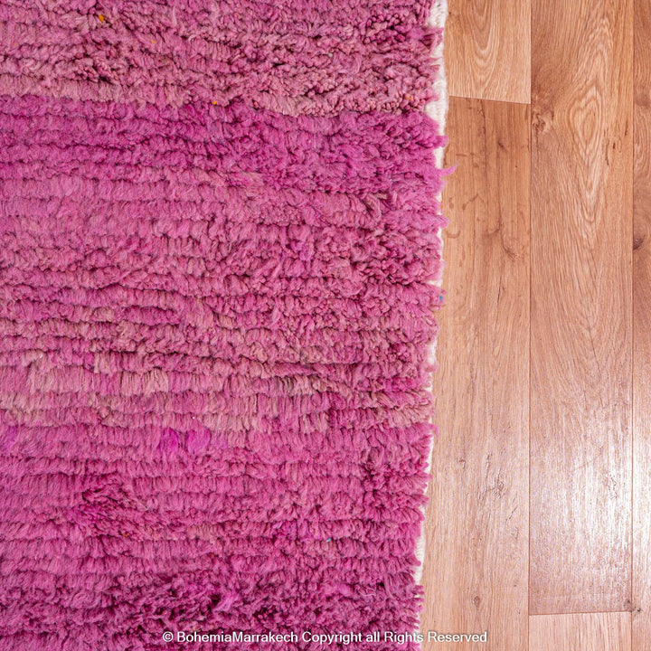 Handmade pink Moroccan wool rug with bold geometric color blocks, crafted by Berber artisans