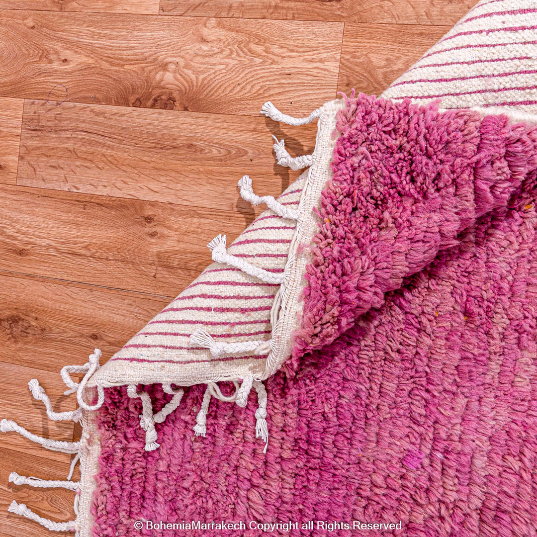 Handmade pink Moroccan wool rug with bold geometric color blocks, crafted by Berber artisans