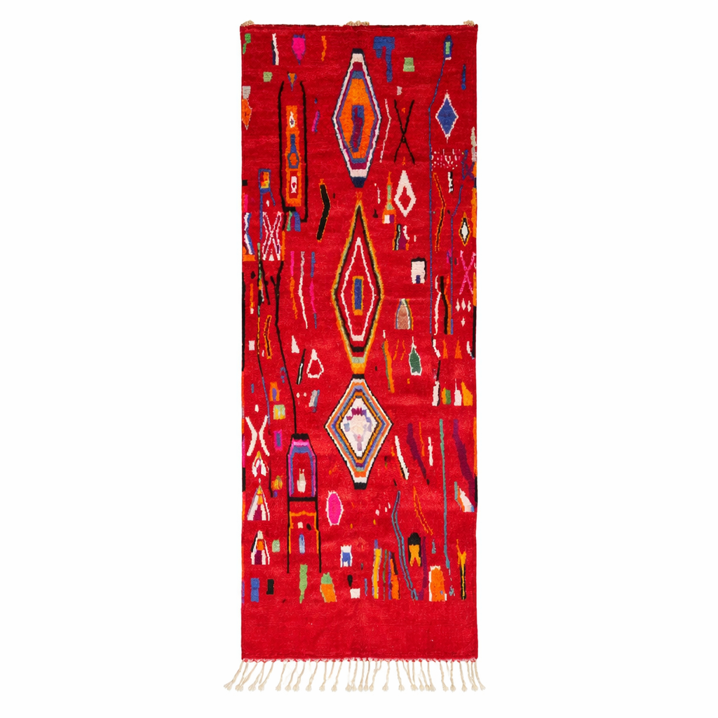Handwoven red Moroccan wool runner rug with colorful Berber tribal patterns