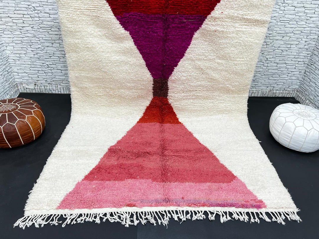 Handwoven Moroccan wool rug in red, pink, and magenta on cream background – modern Berber handmade rug