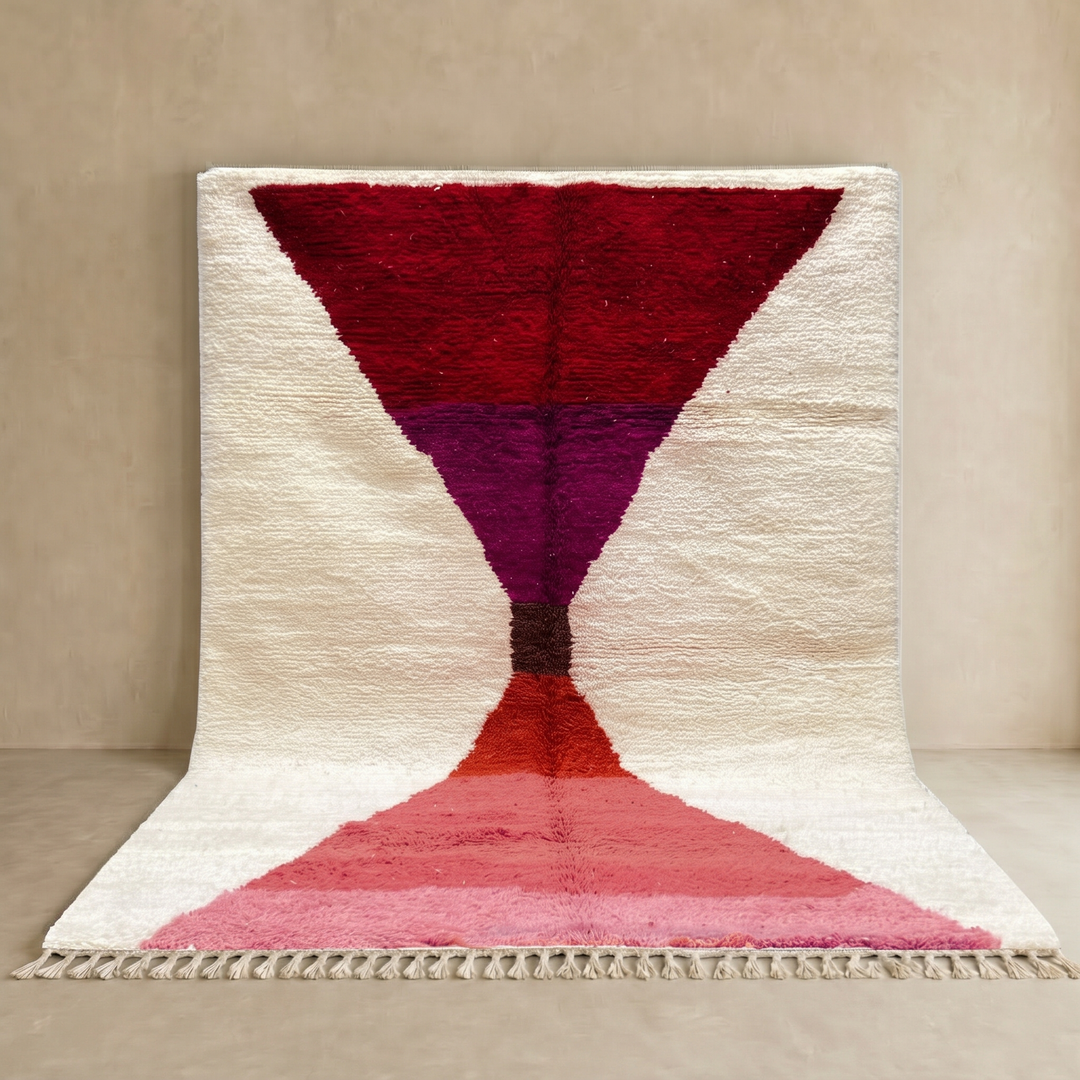 Handwoven Moroccan wool rug in red, pink, and magenta on cream background – modern Berber handmade rug