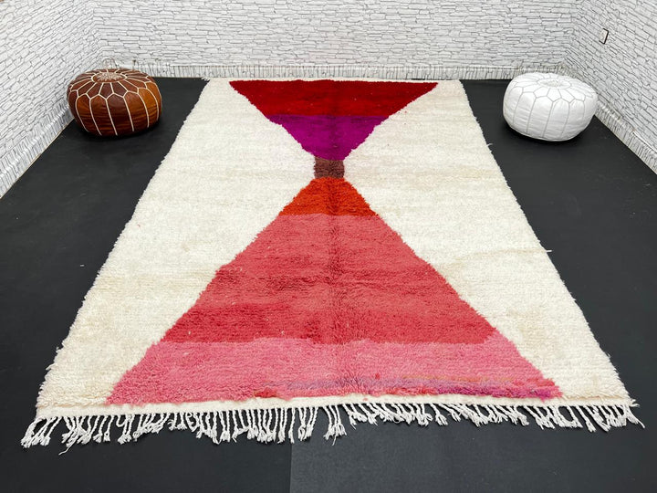 Handwoven Moroccan wool rug in red, pink, and magenta on cream background – modern Berber handmade rug