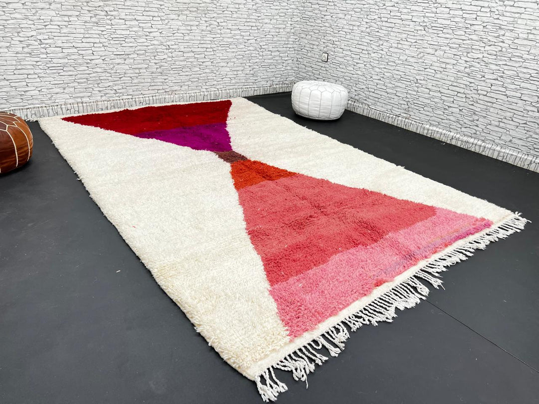 Handwoven Moroccan wool rug in red, pink, and magenta on cream background – modern Berber handmade rug