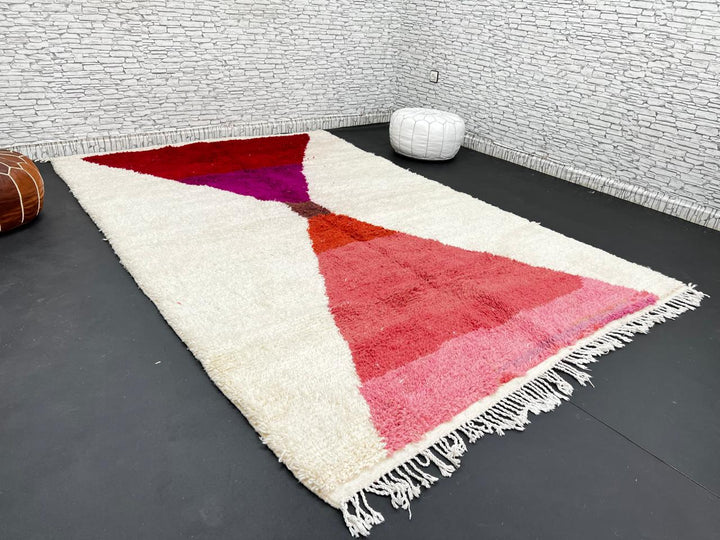 Handwoven Moroccan wool rug in red, pink, and magenta on cream background – modern Berber handmade rug