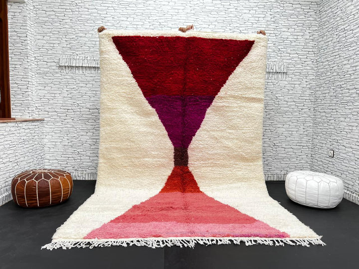 Handwoven Moroccan wool rug in red, pink, and magenta on cream background – modern Berber handmade rug