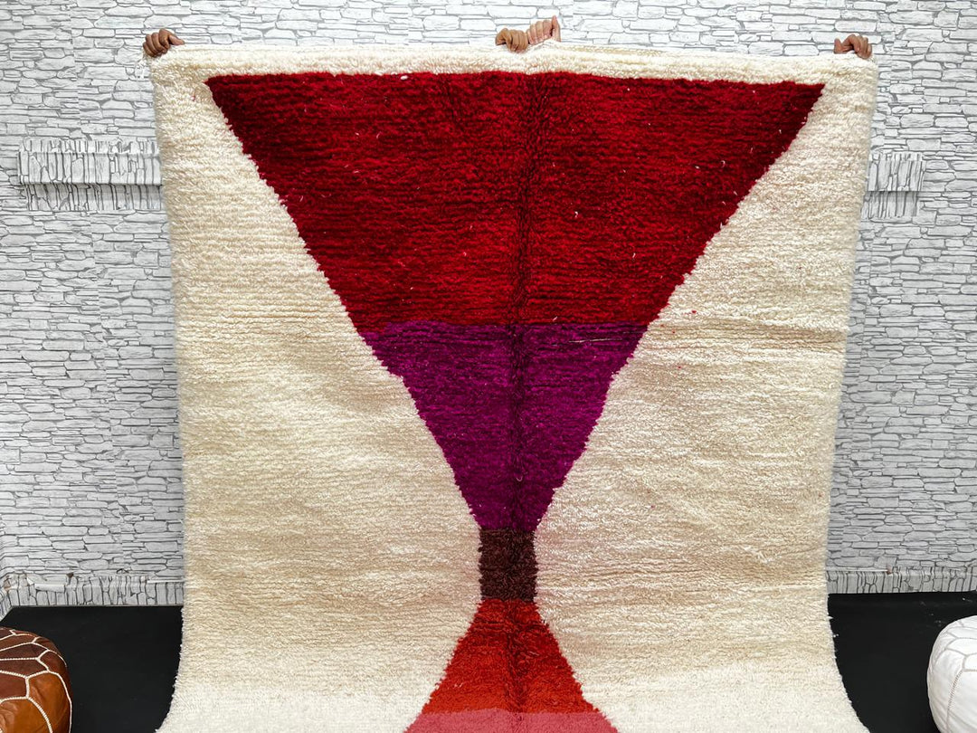 Handwoven Moroccan wool rug in red, pink, and magenta on cream background – modern Berber handmade rug