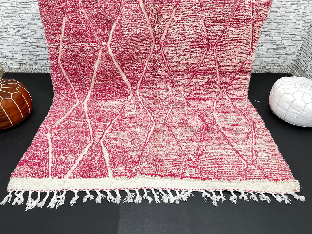 Pink Moroccan wool rug with cream diamond pattern, handmade by Berber artisans in the Atlas Mountains