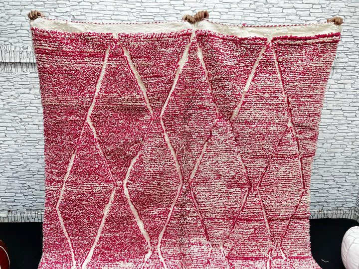 Pink Moroccan wool rug with cream diamond pattern, handmade by Berber artisans in the Atlas Mountains