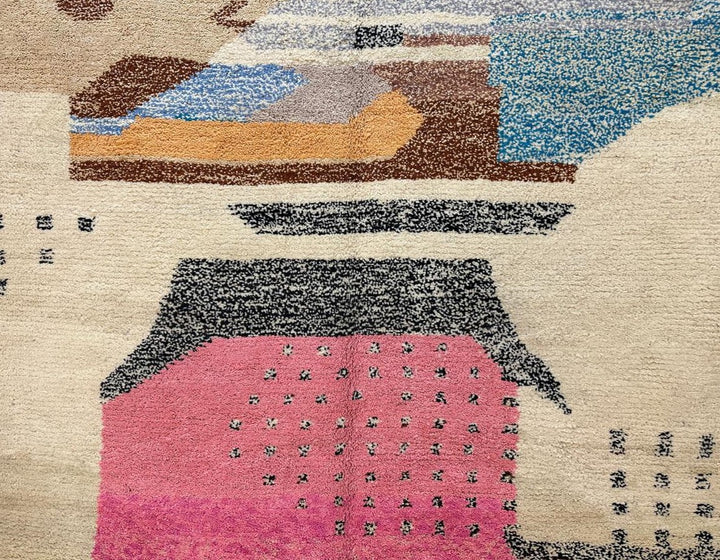 Round handmade Moroccan wool rug with abstract artistic design in pink, blue, caramel and neutral tones