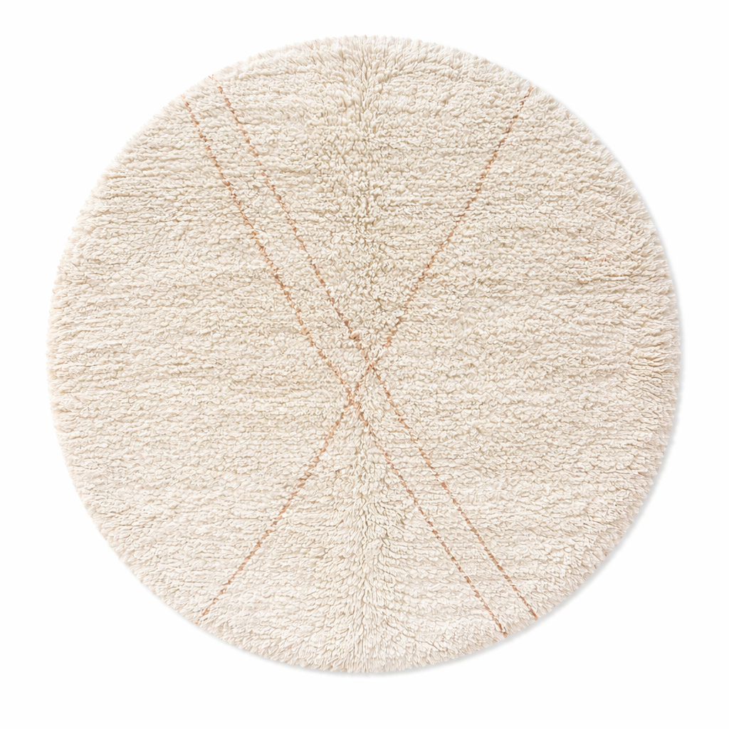 Round handmade Moroccan wool shag rug in cream with subtle Beni Ourain cross pattern on white background