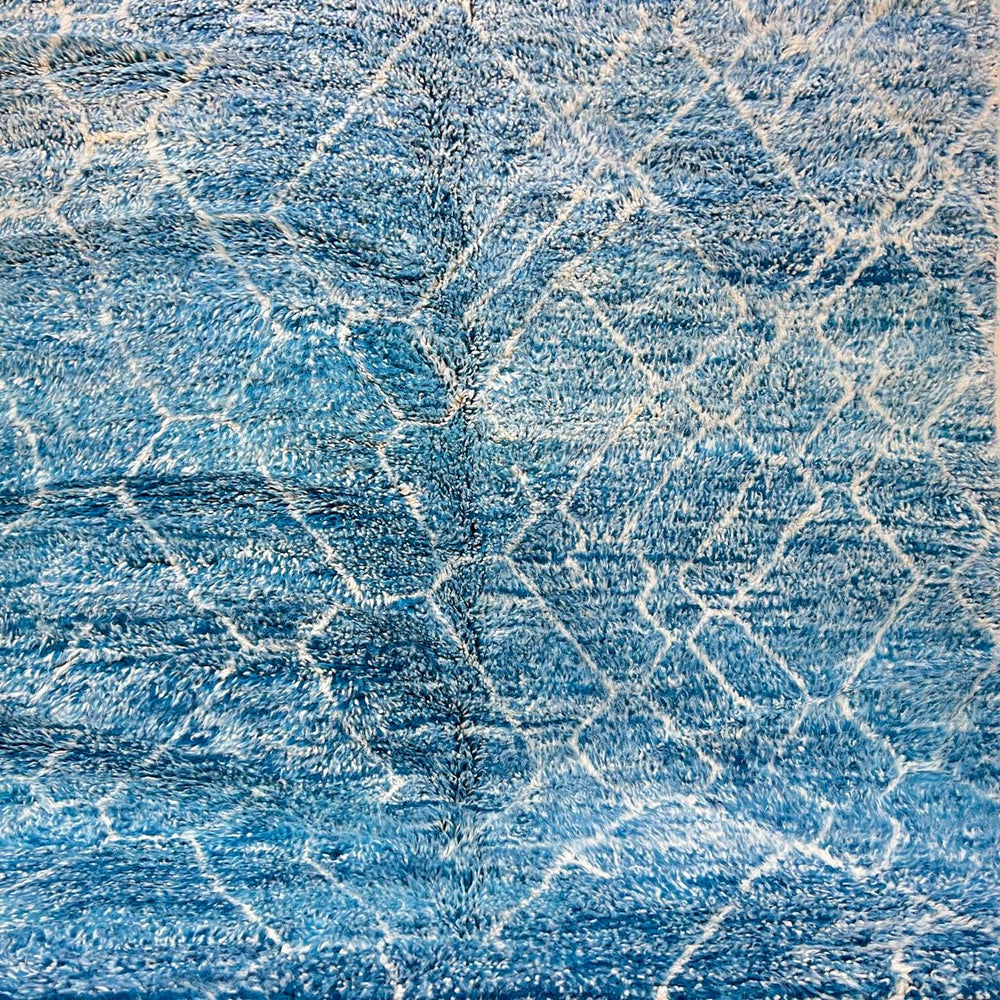 Round blue Moroccan rug with abstract white pattern handmade wool Berber design