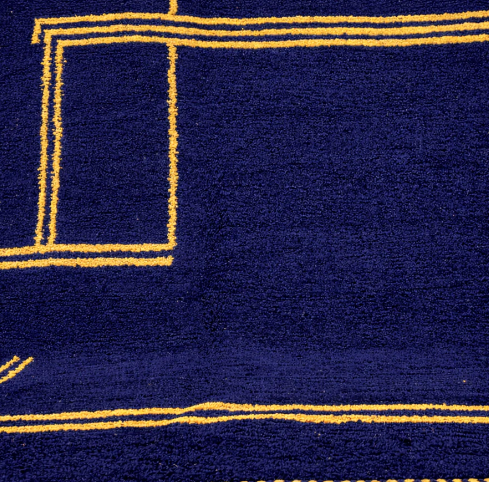 Round navy blue Moroccan wool rug with mustard yellow geometric Berber pattern, handmade artisan round carpet on white background