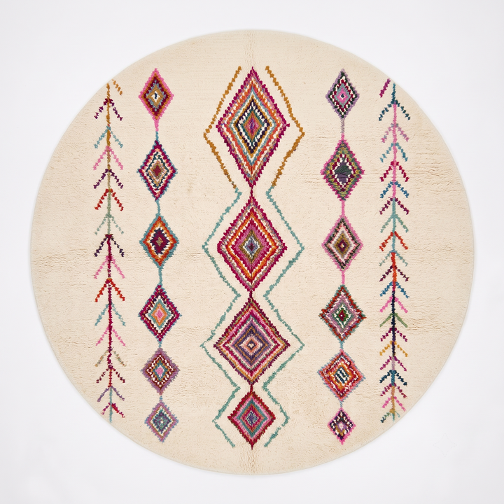 Round white Moroccan wool rug with colorful diamond and tribal line motifs handmade by Berber artisans